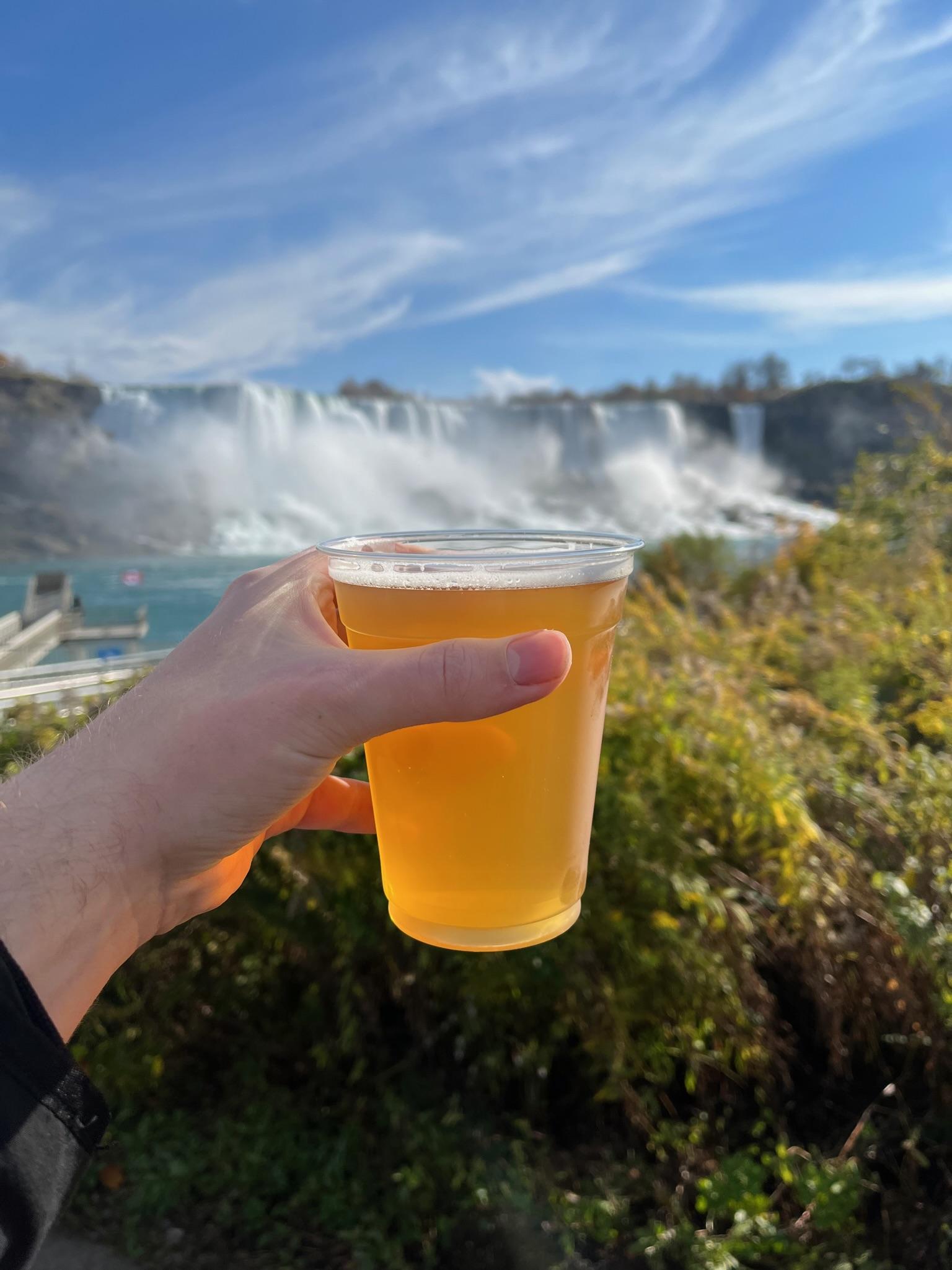Drinking a cold beverage with the Niagara Falls in the background