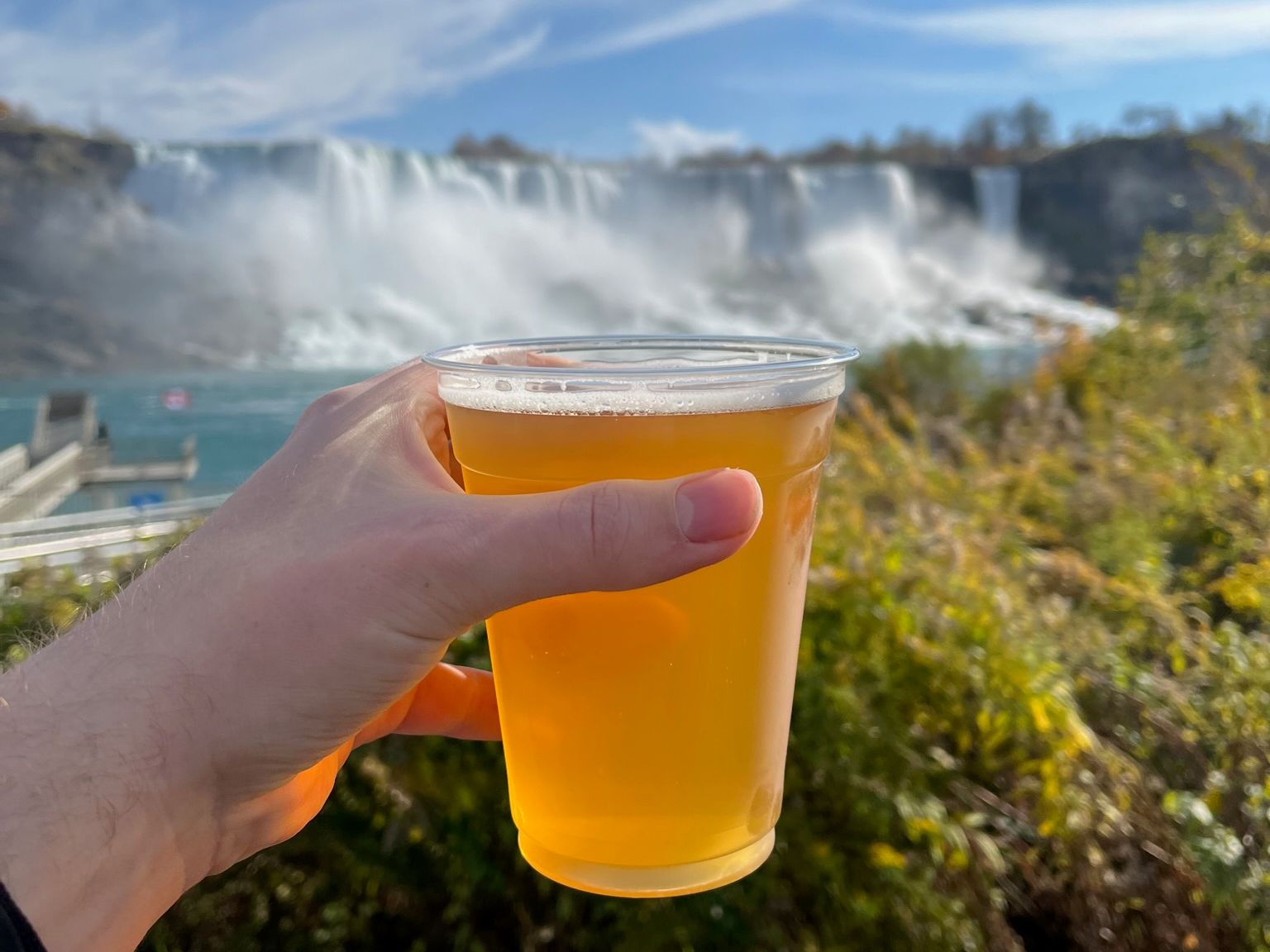 Drinking a cold beverage with the Niagara Falls in the background
